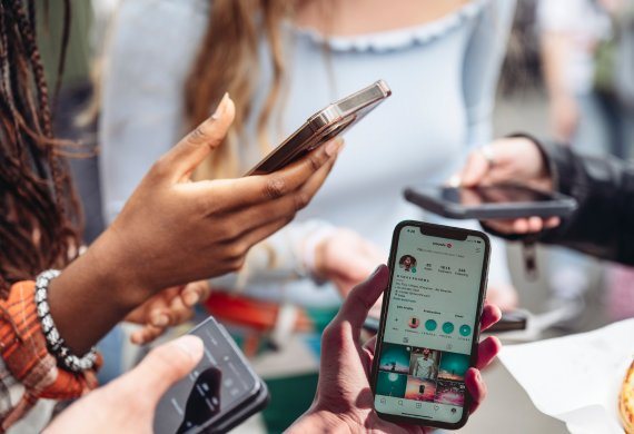 Young adults viewing social media sites on cell phones